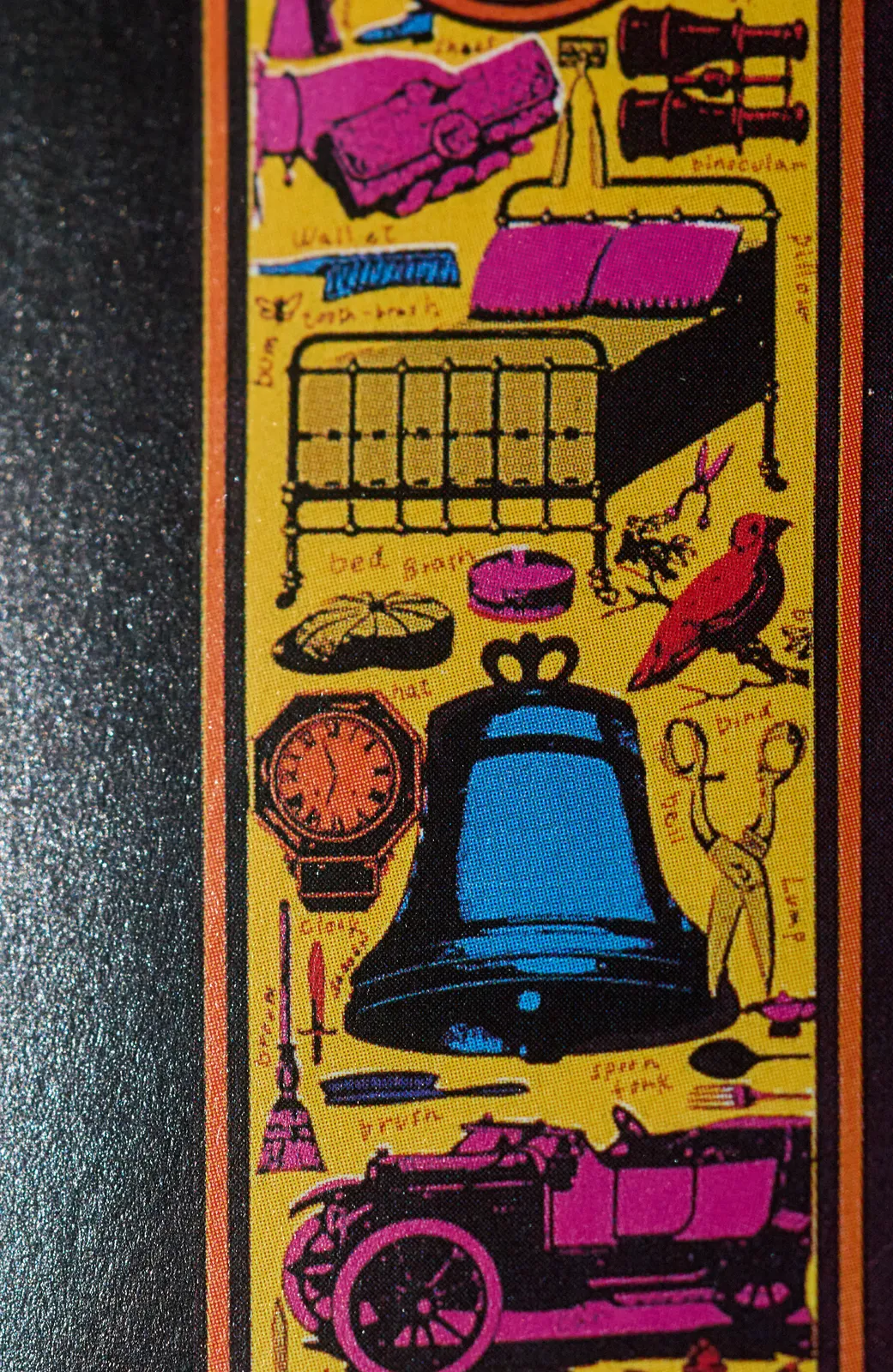 A collage of brightly coloured old fashioned things, like an old car, glasses, a bell, scissors, a bed, and a shoe. And of course an old fashioned clock which points at 3 minutes to seven.