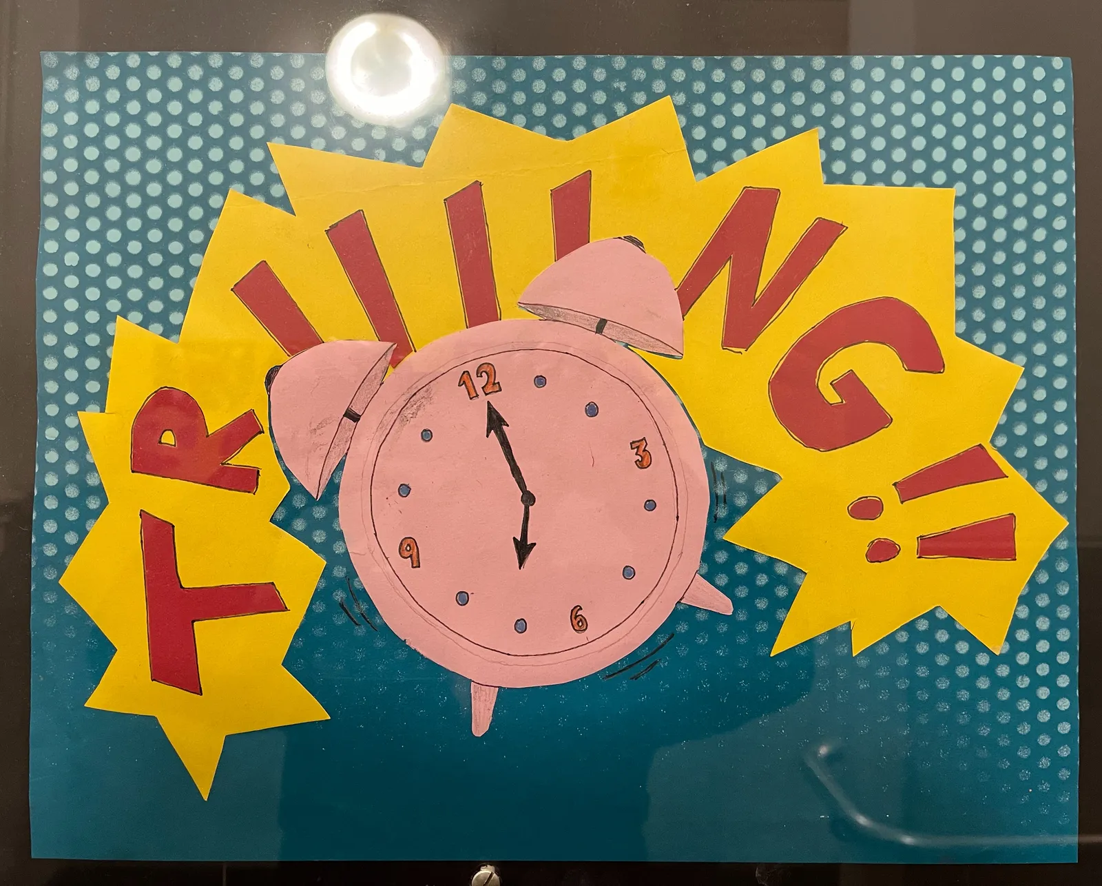 An image in pop-art style with an old, fashioned, pink alarm clock that points at 7 o’clock. In large, red on yellow letters behind it, it says TRIIIING. 