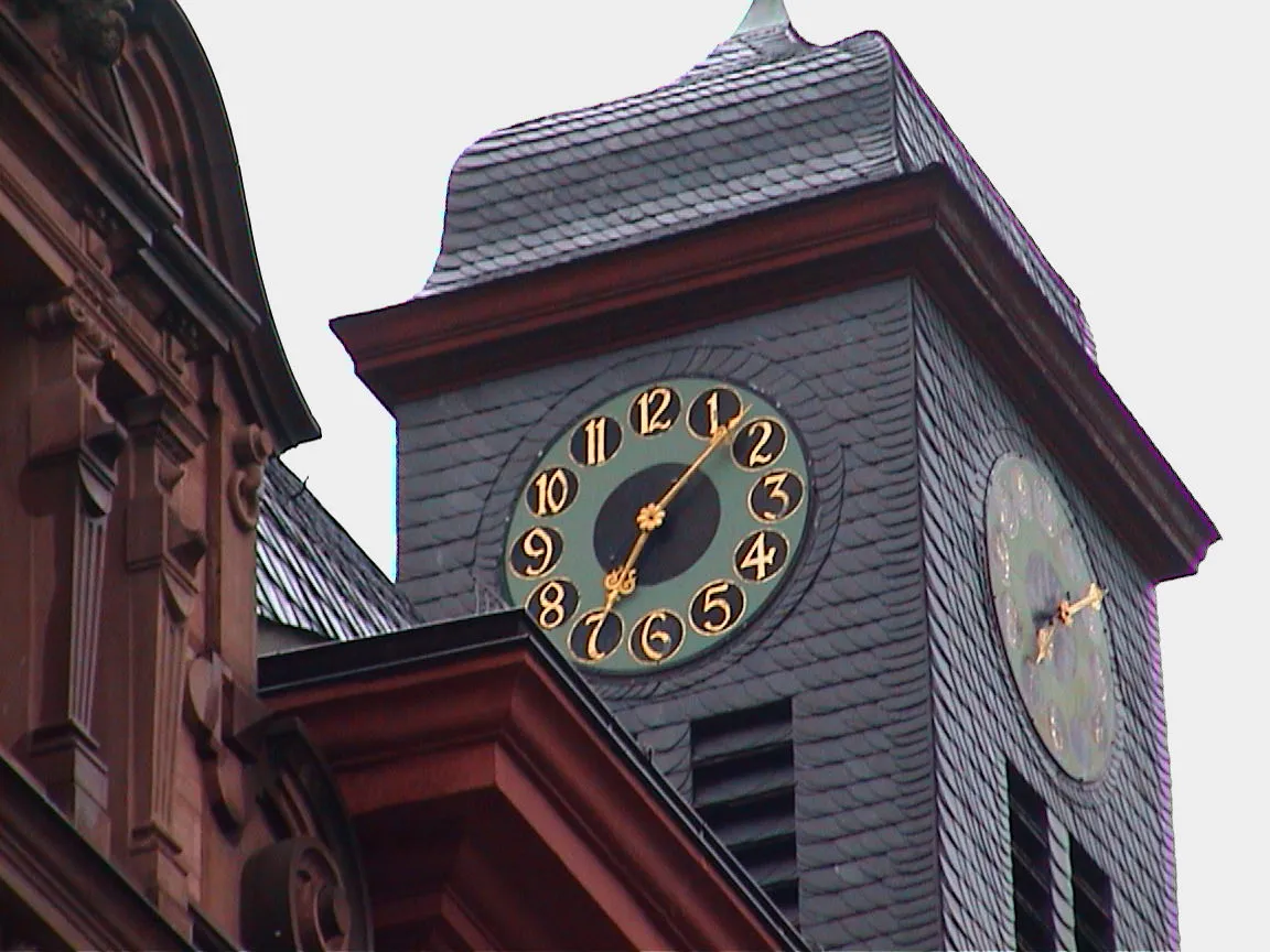 Two visible clocks on this church tower point at seven past seven.