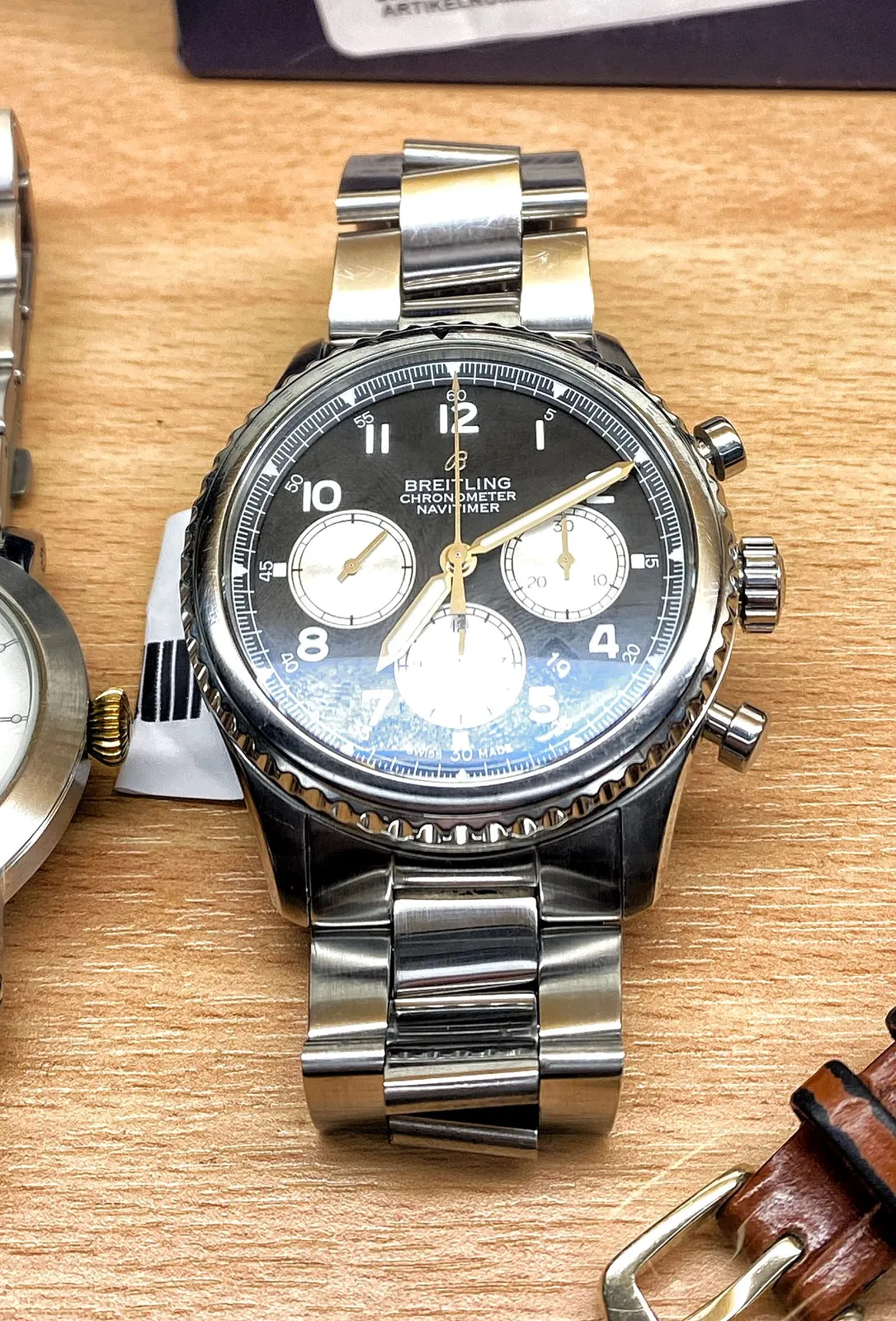 A Breitling Chronometer Navimeter wrist watch. It points at 10 past 7.