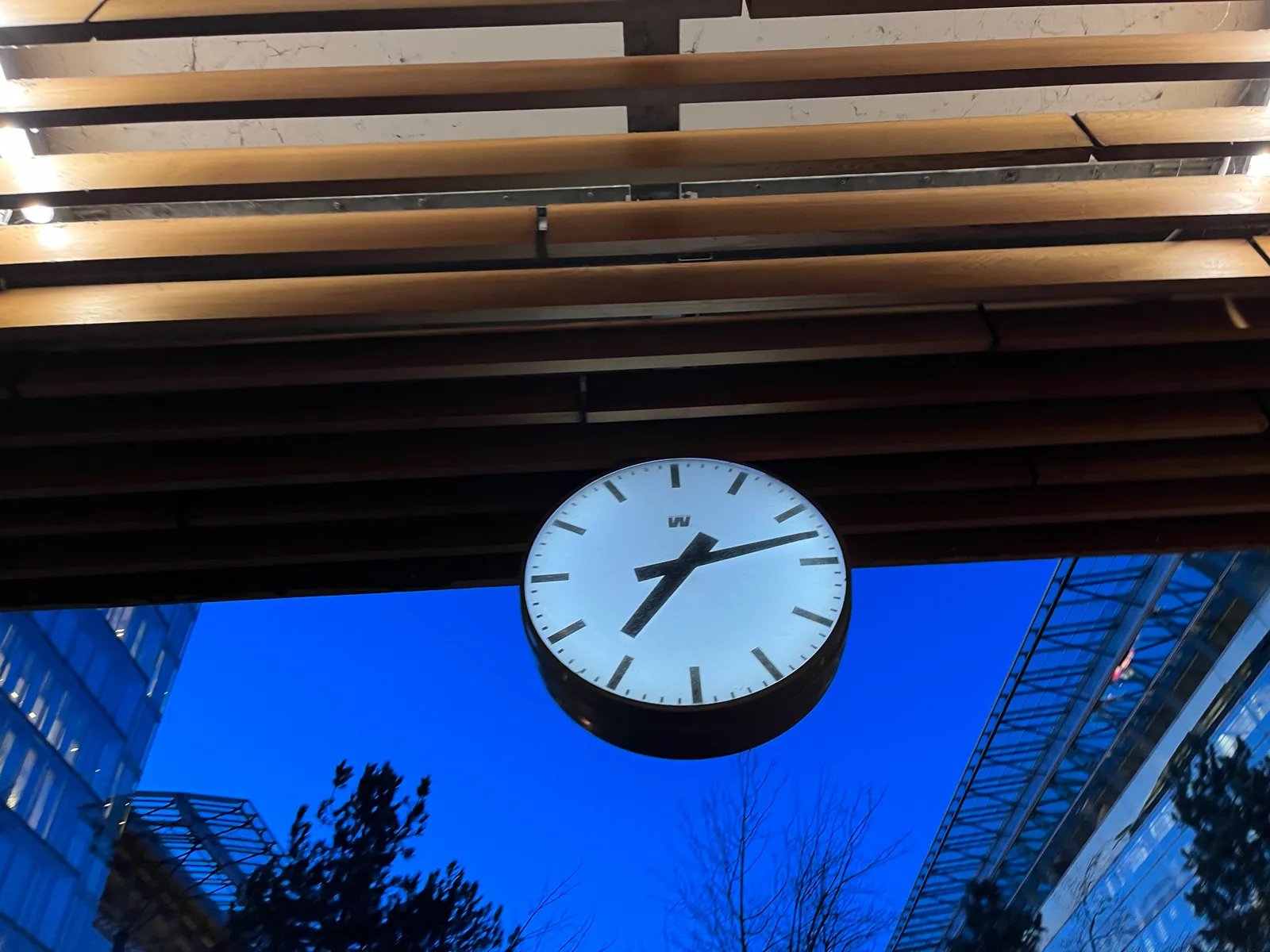 This clock on the Zuidas in Amsterdam points at 12 past 7.