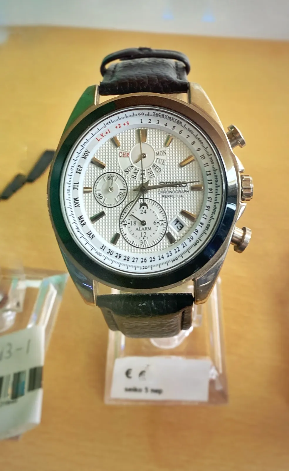 A wrist watch. It points at 14 past 7.