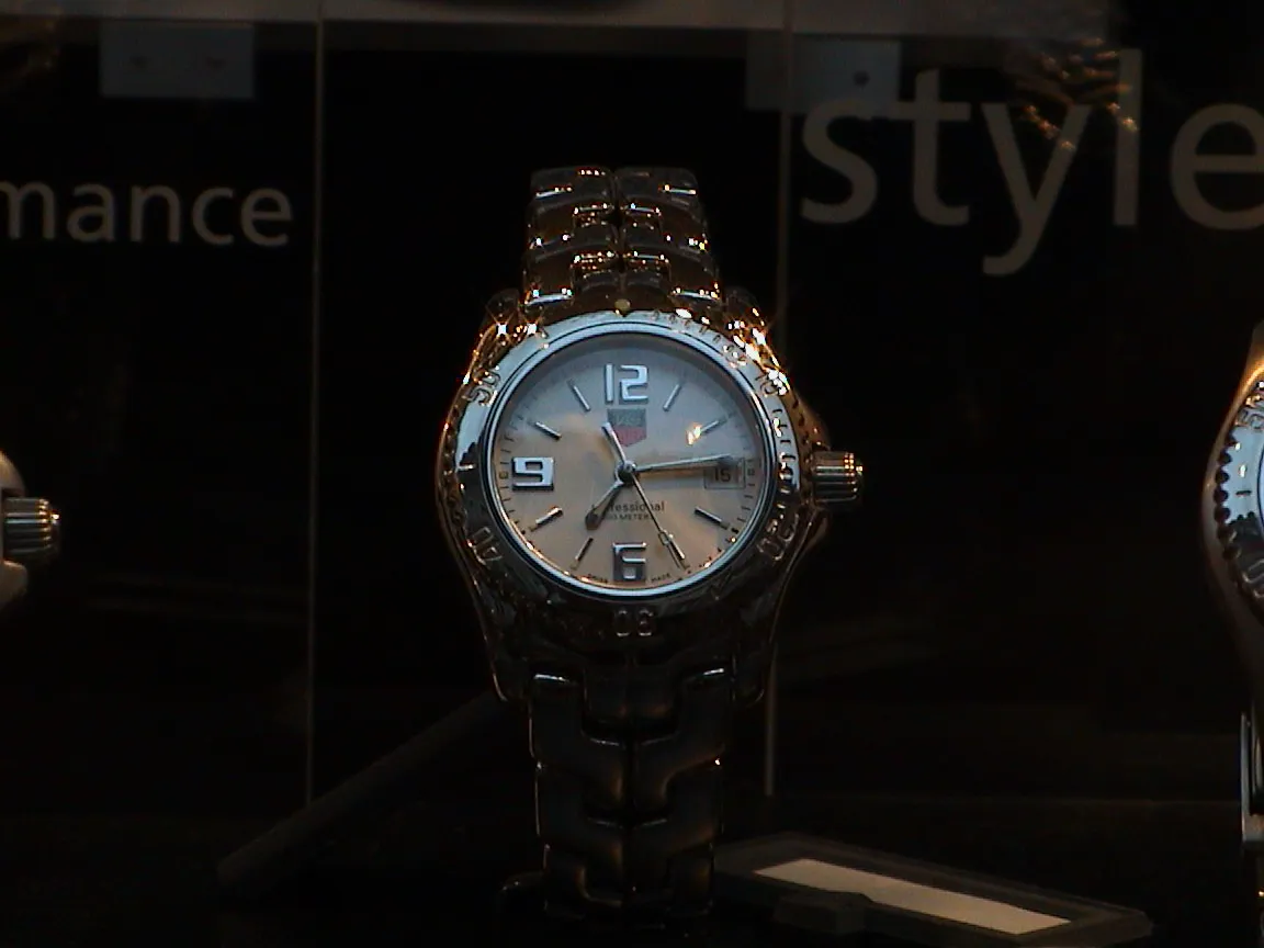 This watch points at fourteen past seven.