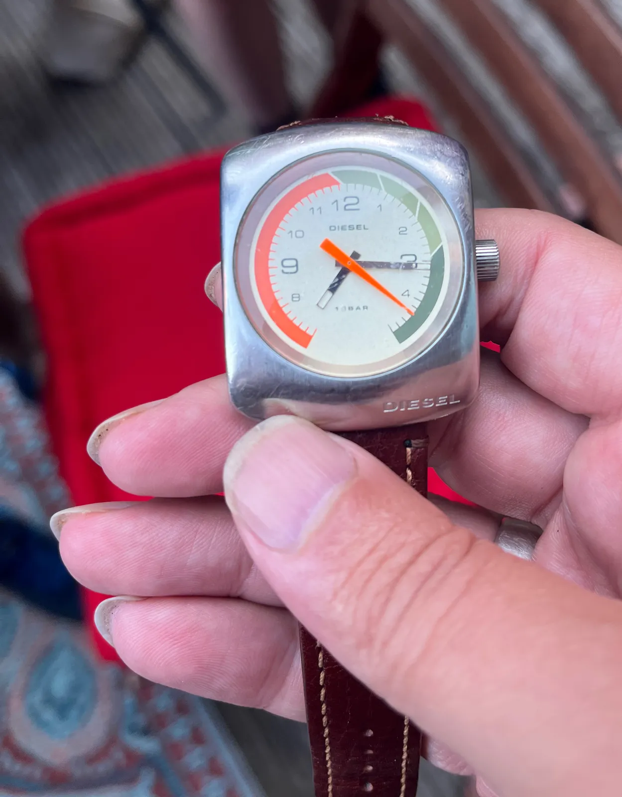 A wrist watch which looks more like some sort of speed meter is actually a clock indeed. It points at 16 past 7.