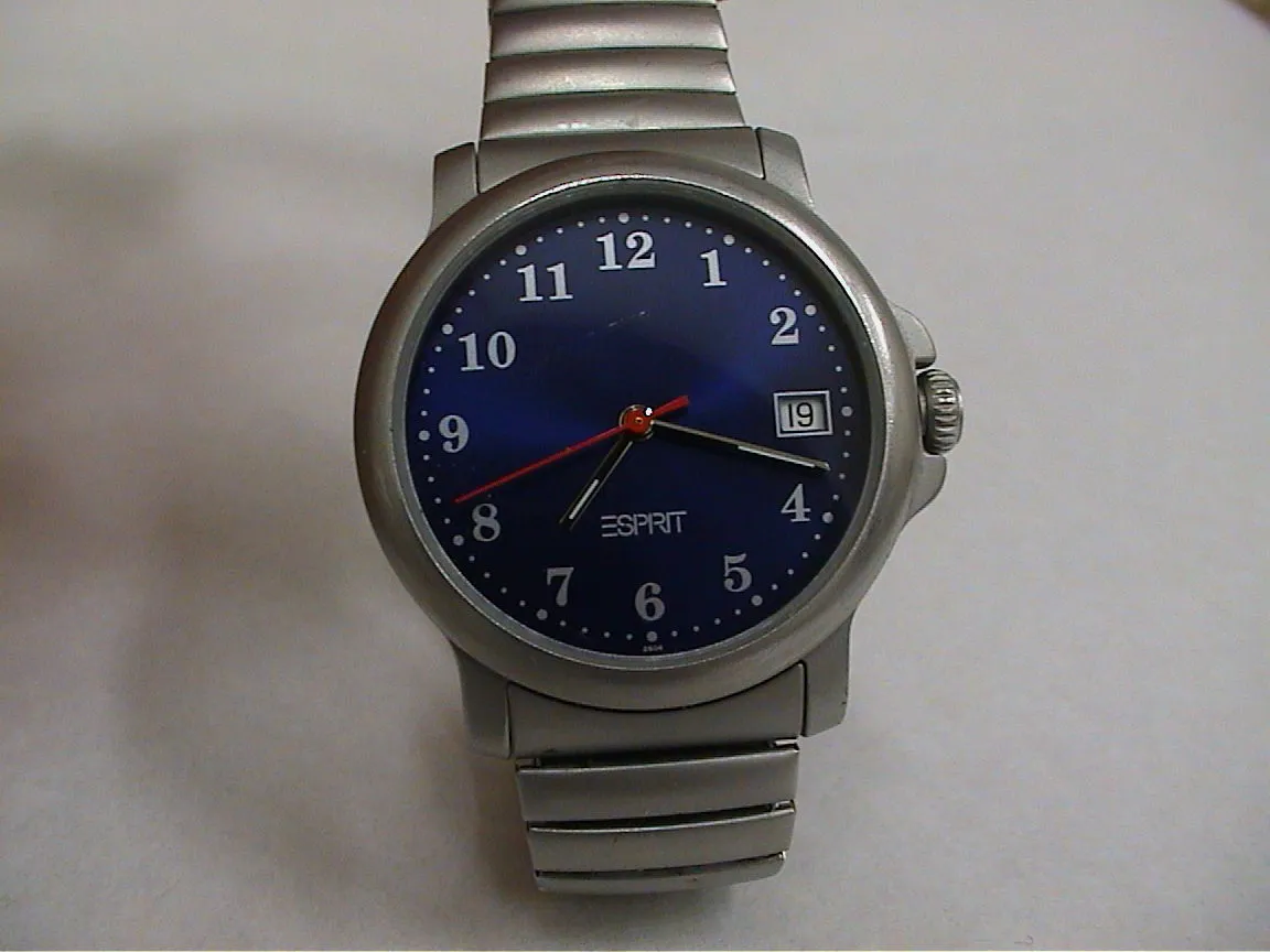 This blue watch points at eighteen past seven.