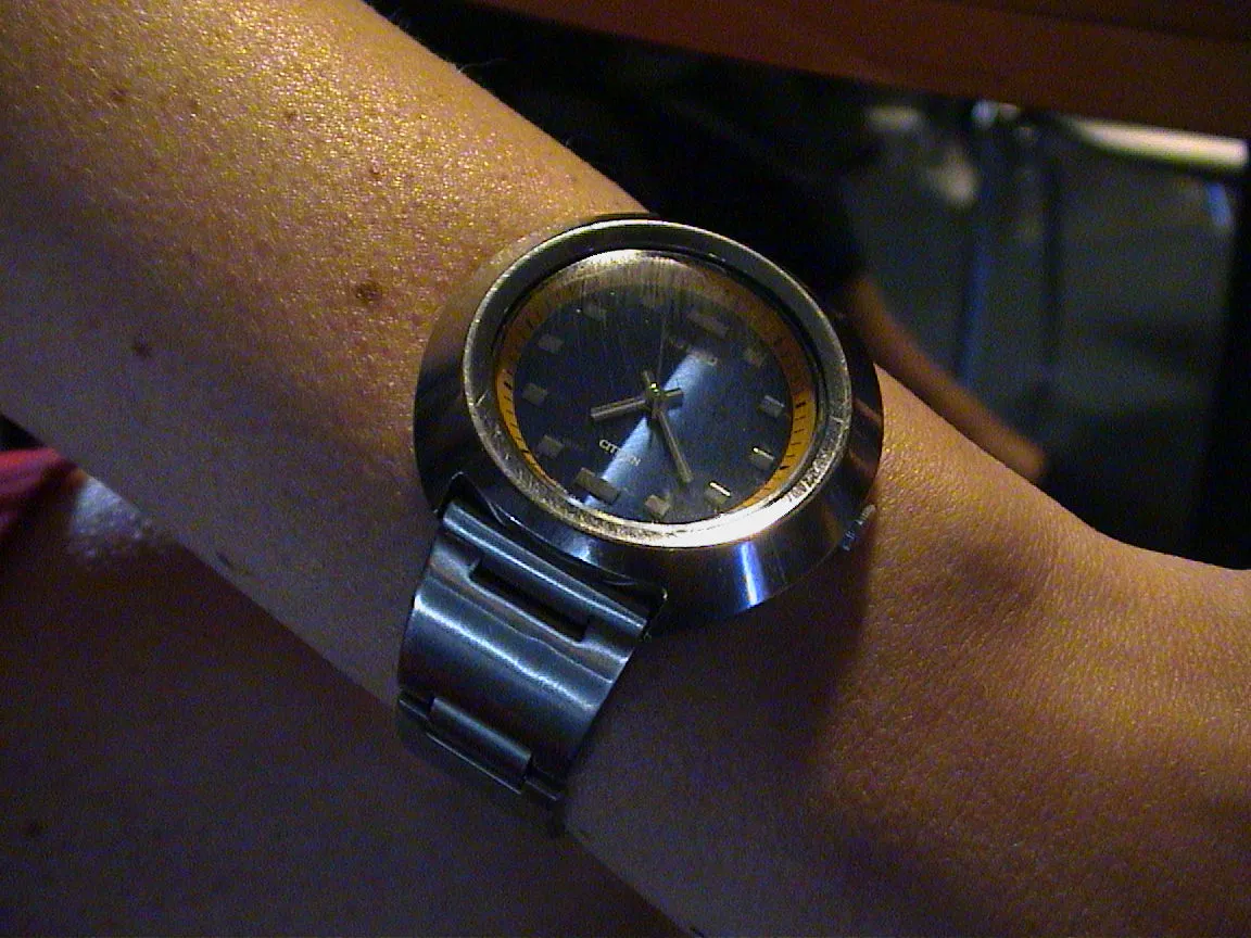 This wrist watch points at 22 past seven.