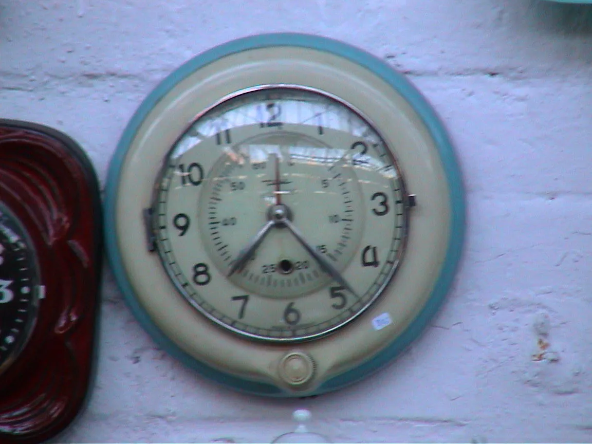 This wall clock points at twenty four past seven.