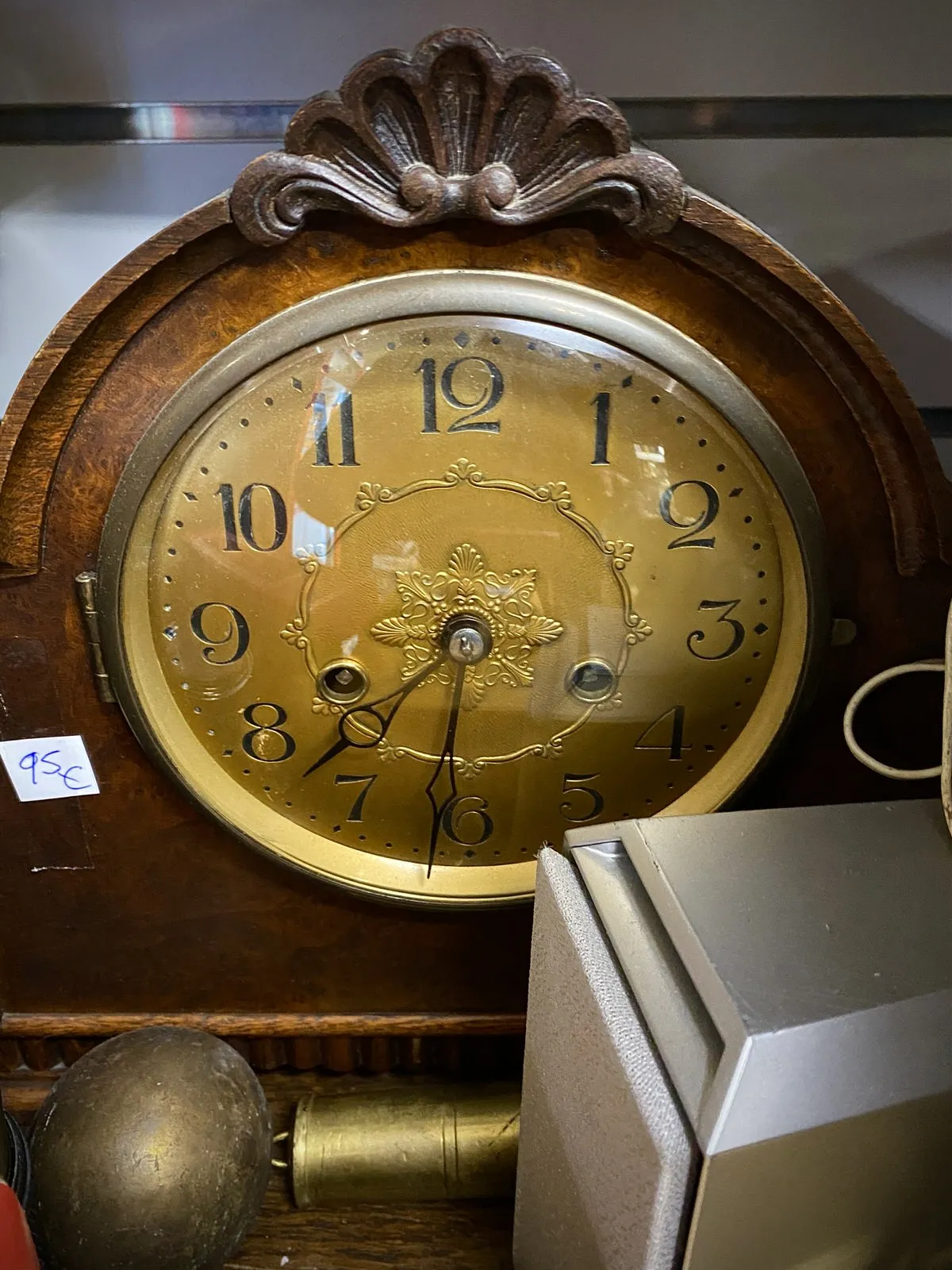 An old wooden clock (for sale for 95 euro) points at 31 past seven.
