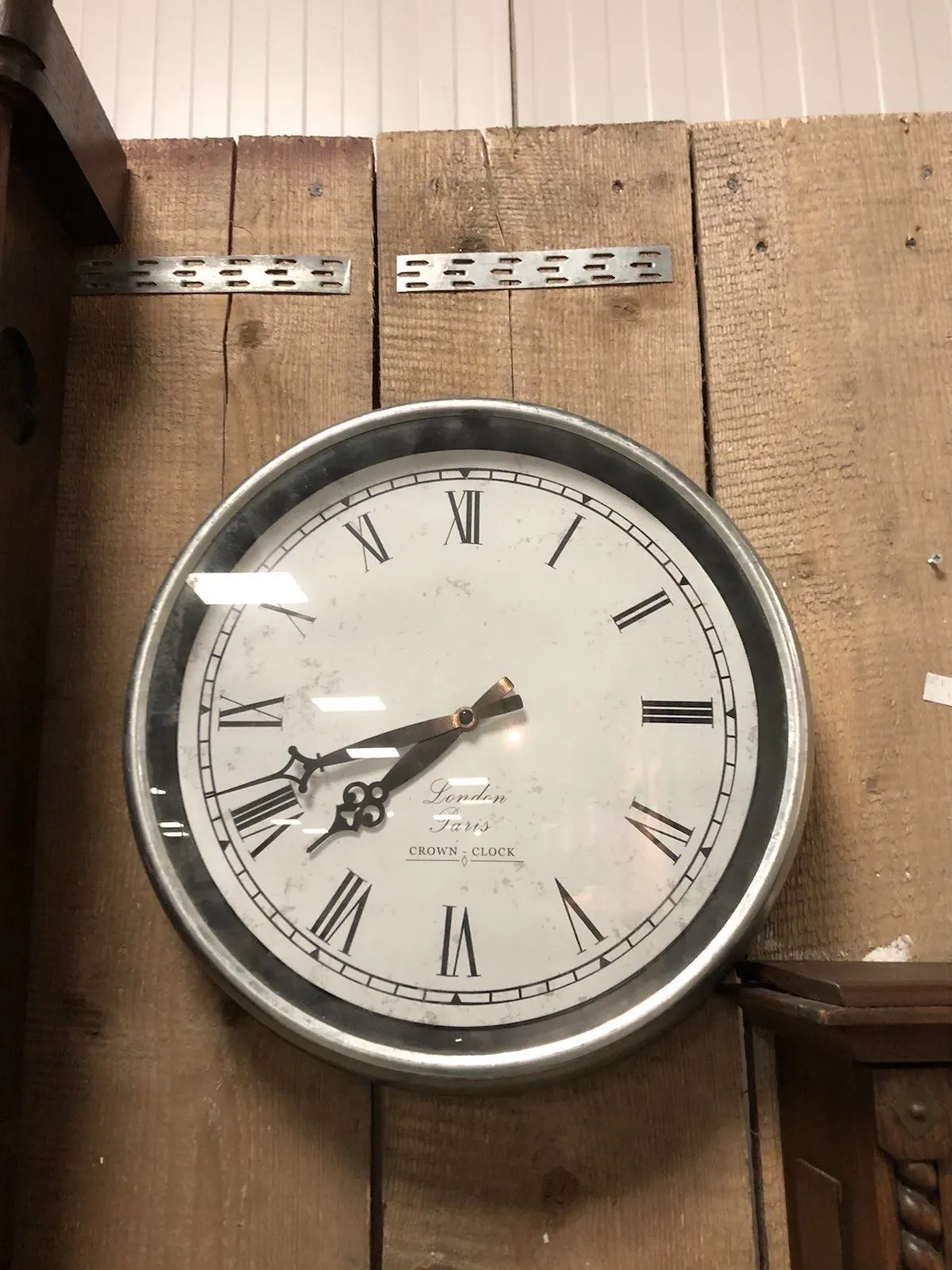 On the face of the clock the words London Paris crown clock. It points at 41 past seven.
