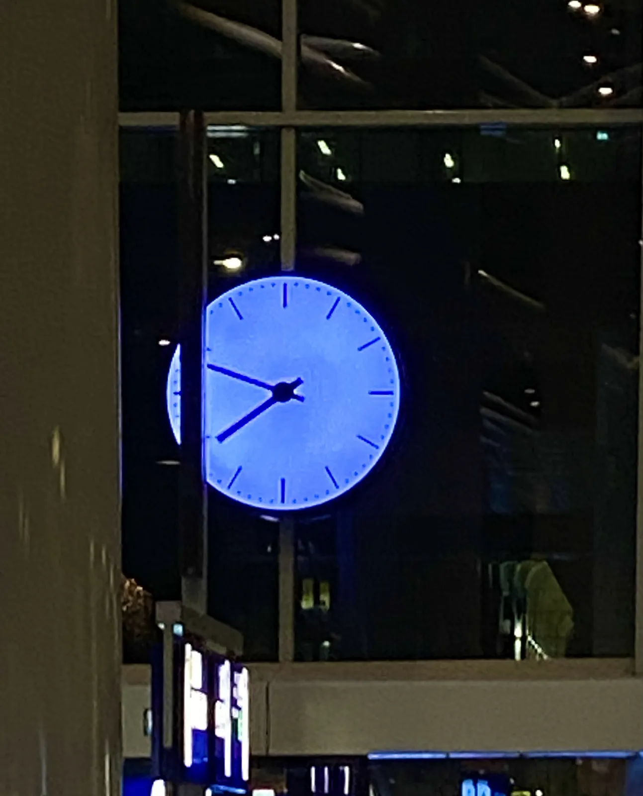 A large clock on a Dutch train station. It points at 12 minutes to 8.
