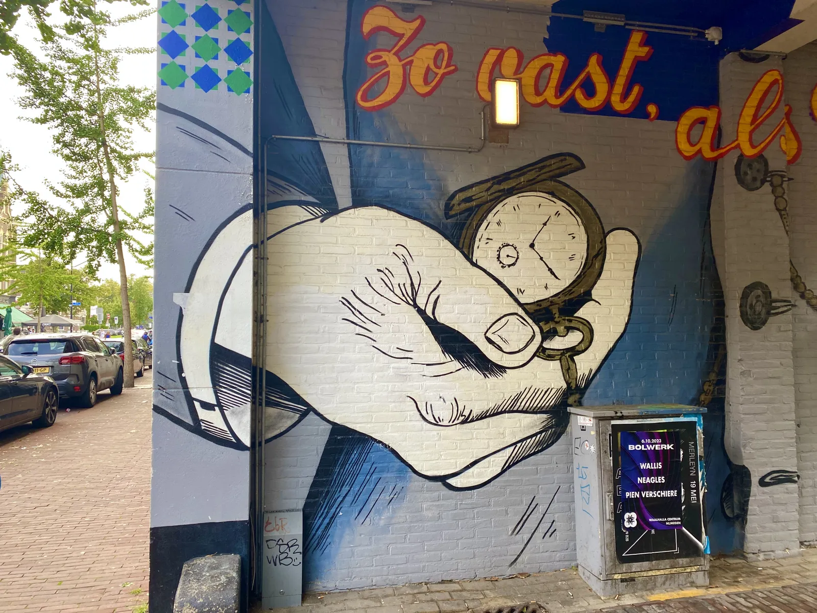A mural painting of a person holding an old fashioned hand watch. It’s not entirely clear what time it is on the watch, but it could very well be four minutes to eight.