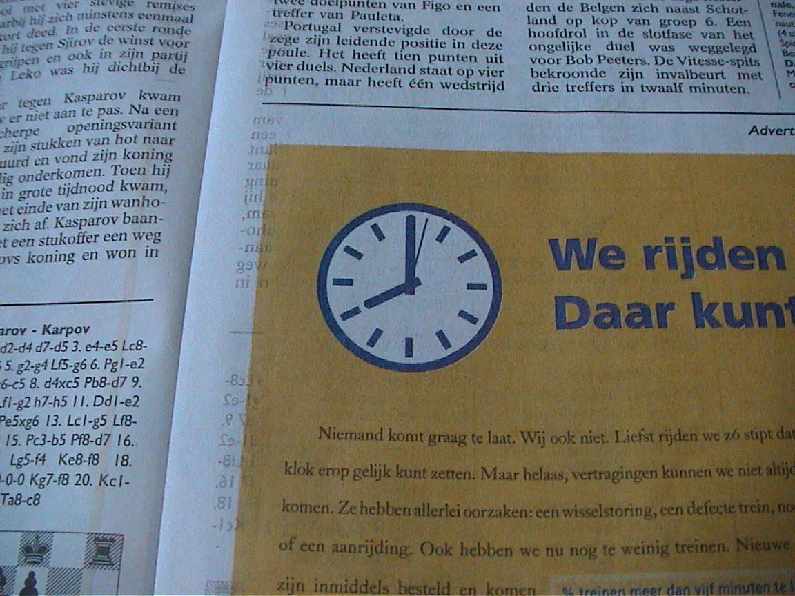 A clock in a newspaper ad points at eight o’clock.
