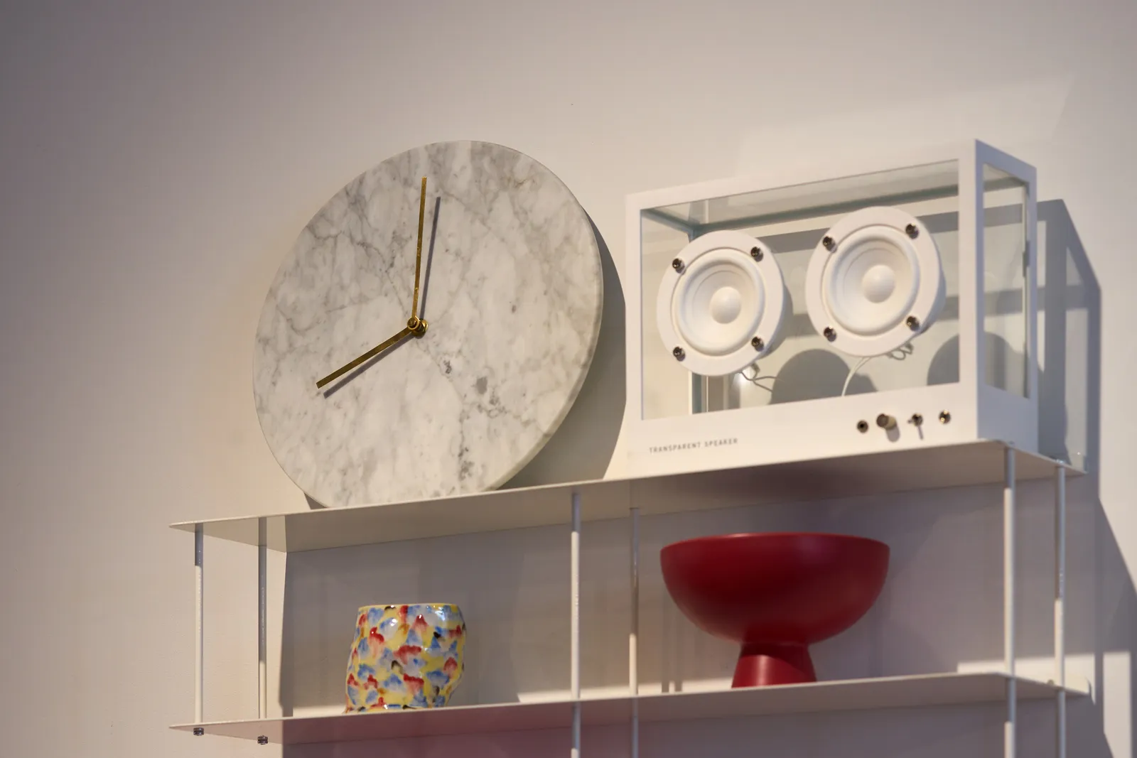 A clock made from marble. It’s surrounded by design stuff. It points at 8 o’clock.