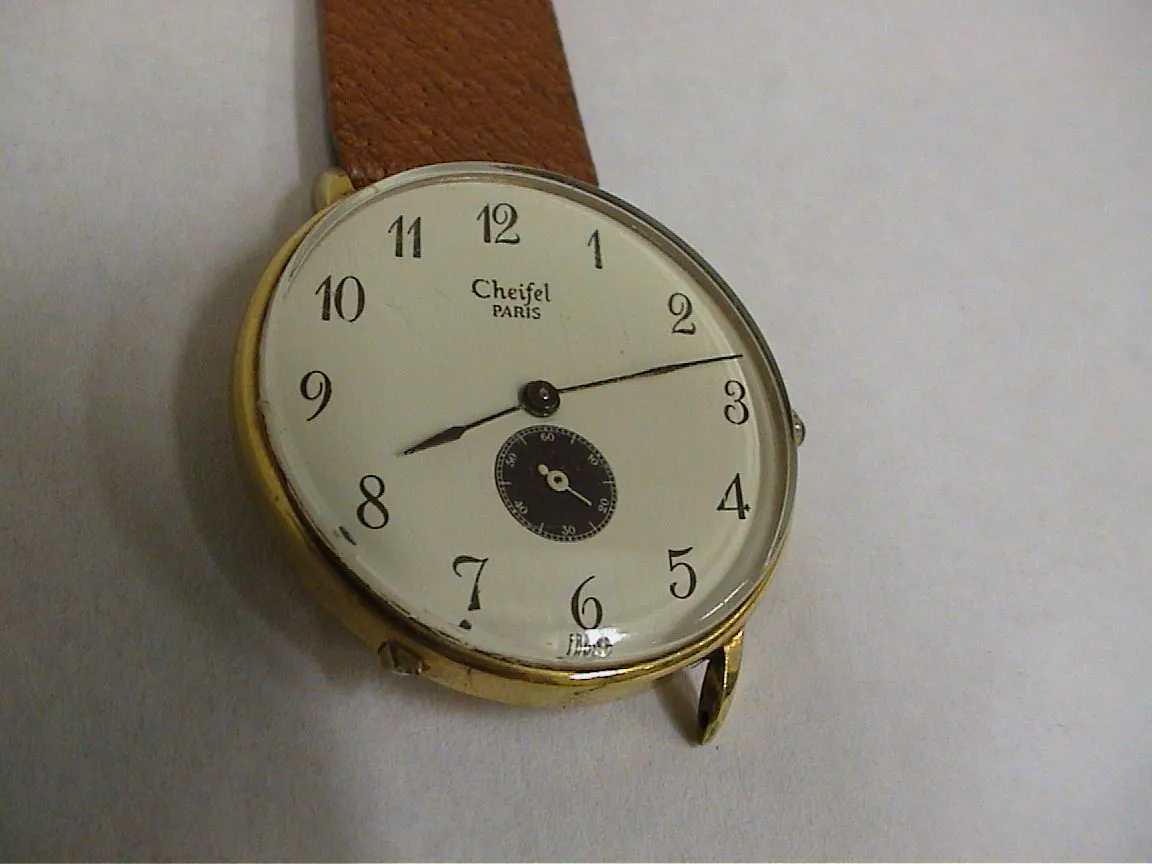 This watch — one part broke of, that’s why it only has one strap — points at twelve past eight.