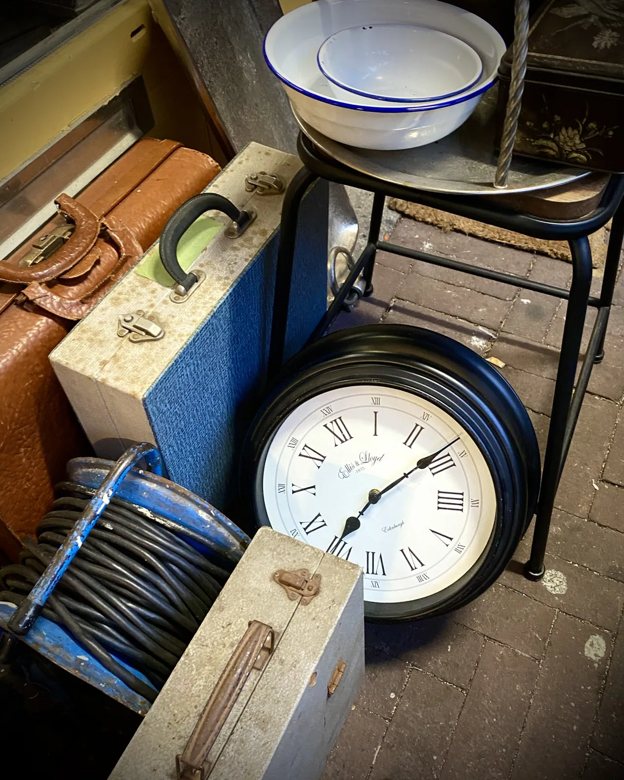 Between all this stuff in a thrift shop there’s a clock that points at 13 past 8.