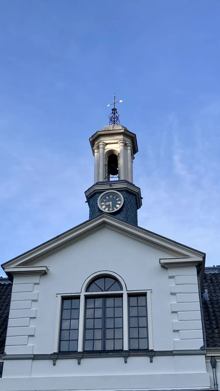 A little church tower with a clock on it. It points at 29 minutes past 8. 