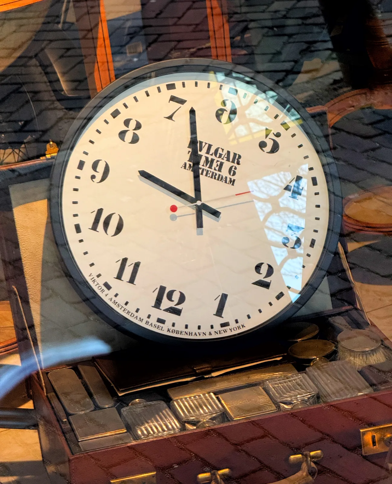 A confusing clock. The six is at the top, instead of the twelve, and the twelve is at the bottom. It also runs counter clockwise, which makes it extra confusing. Once you get it, you can see that it points at 33 minutes past eight.