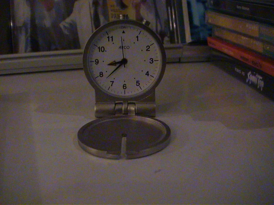 A travel clock points at almost 38 past eight.