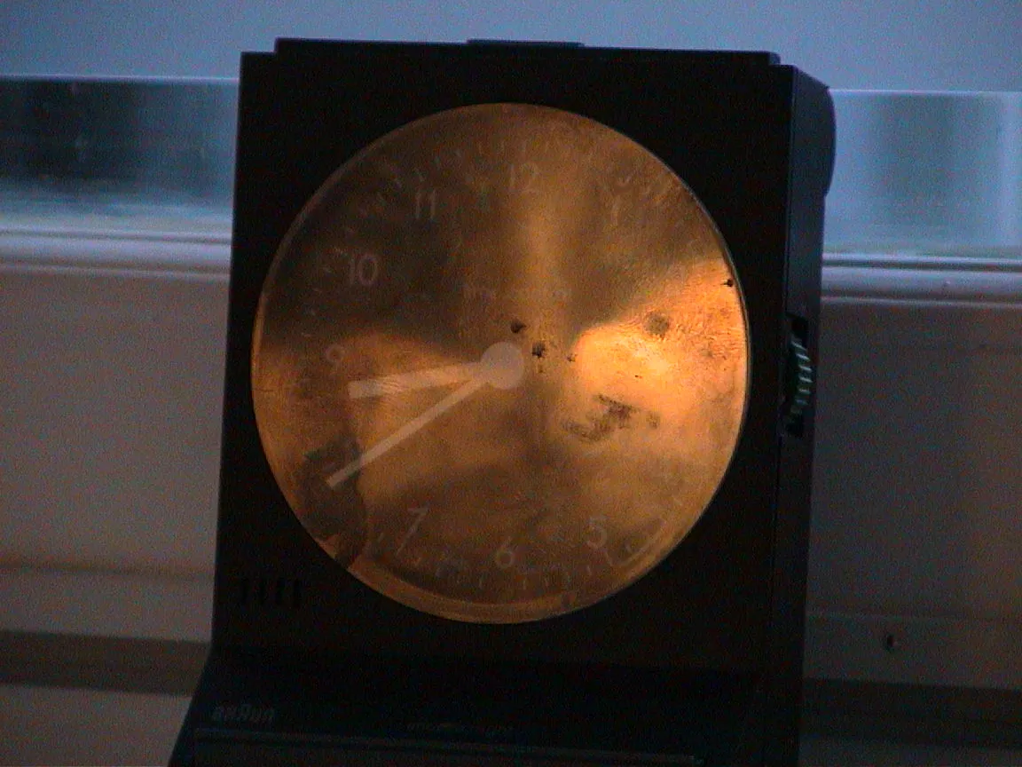 A small travel clock points at eight 39.