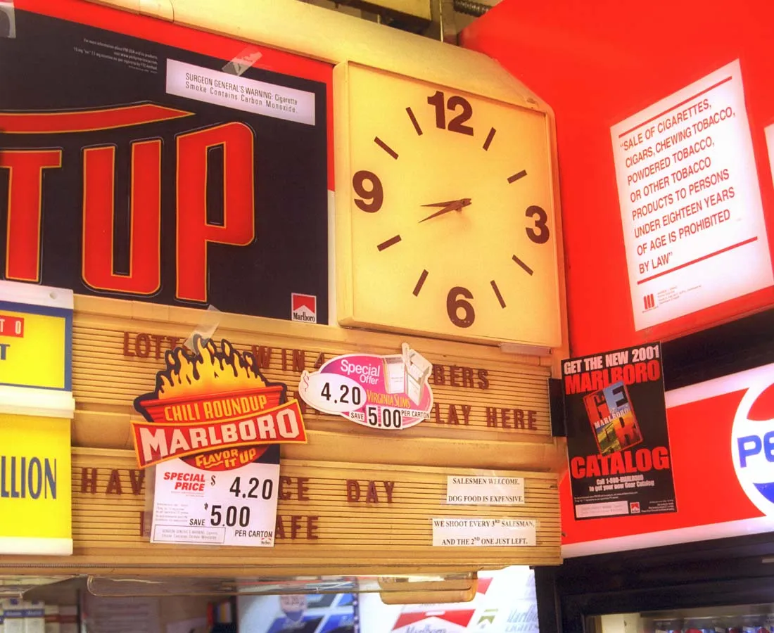Lots of stuff to be seen behind this counter. Of of the things is a clock that points at twenty to nine.
