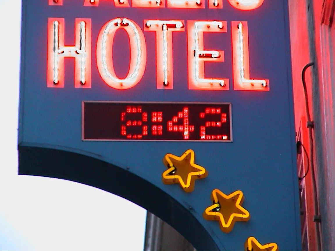The clock in this neon hotel sign says it is 08:42