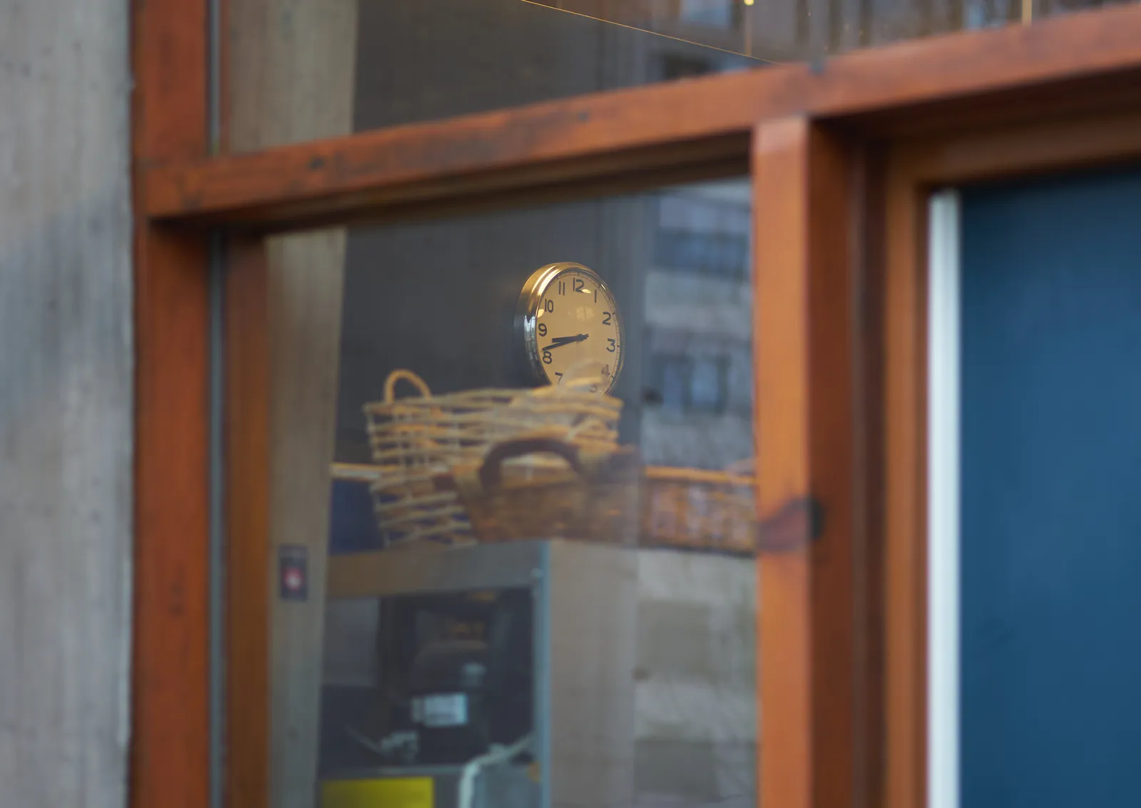 Peeking through a window you can see a clock that points at 18 to nine.