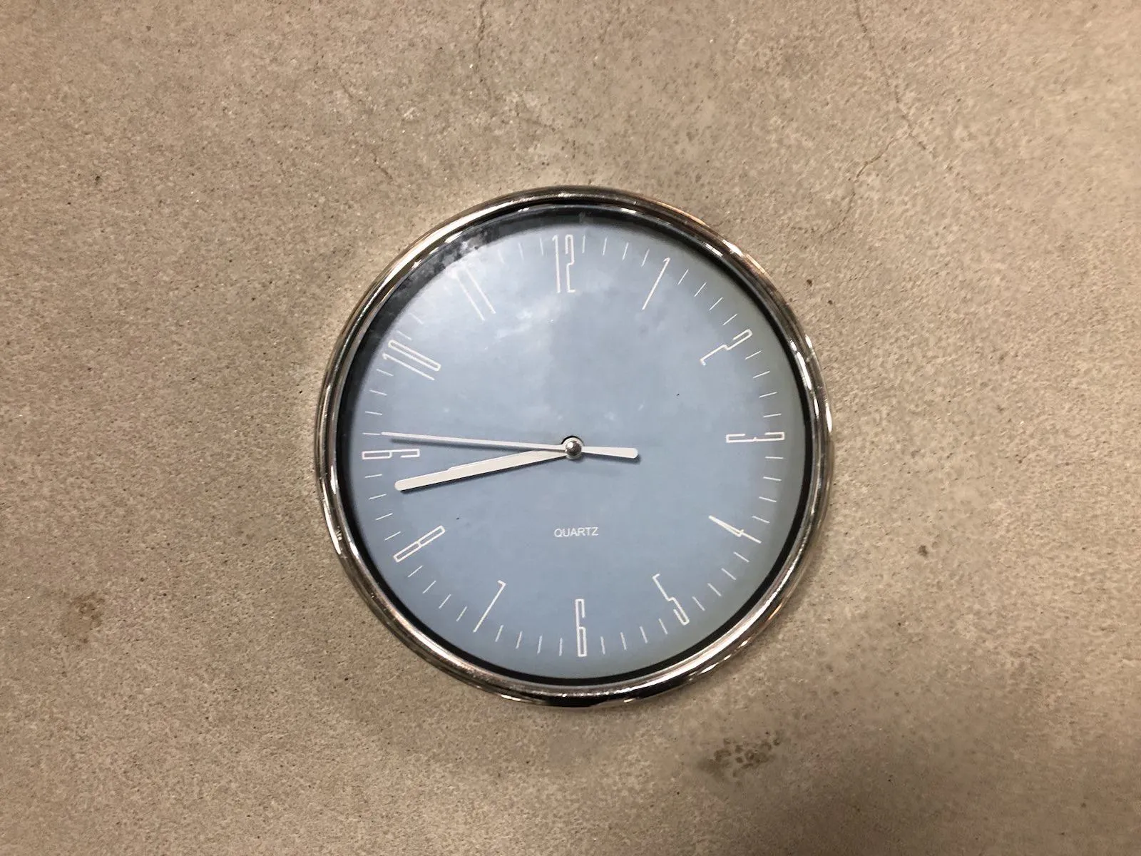 It is a bit hard to see but when you look closely you can see that this clock points at 17 minutes to nine.