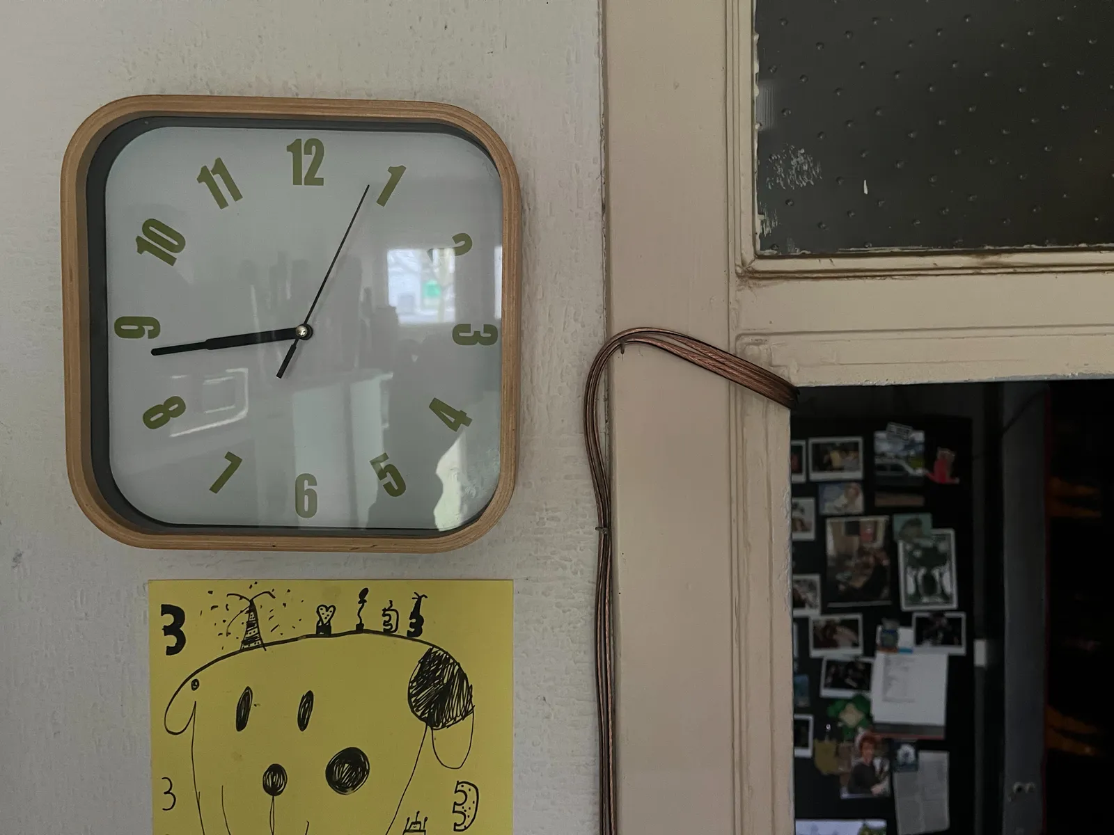 A kitchen clock. It points at 16 minutes to 9.
