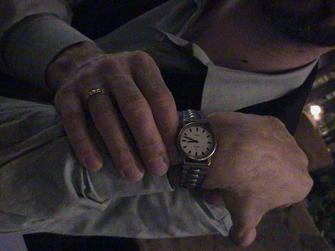 The person who wears this watch twists their arm to show that it is thirteen to nine.