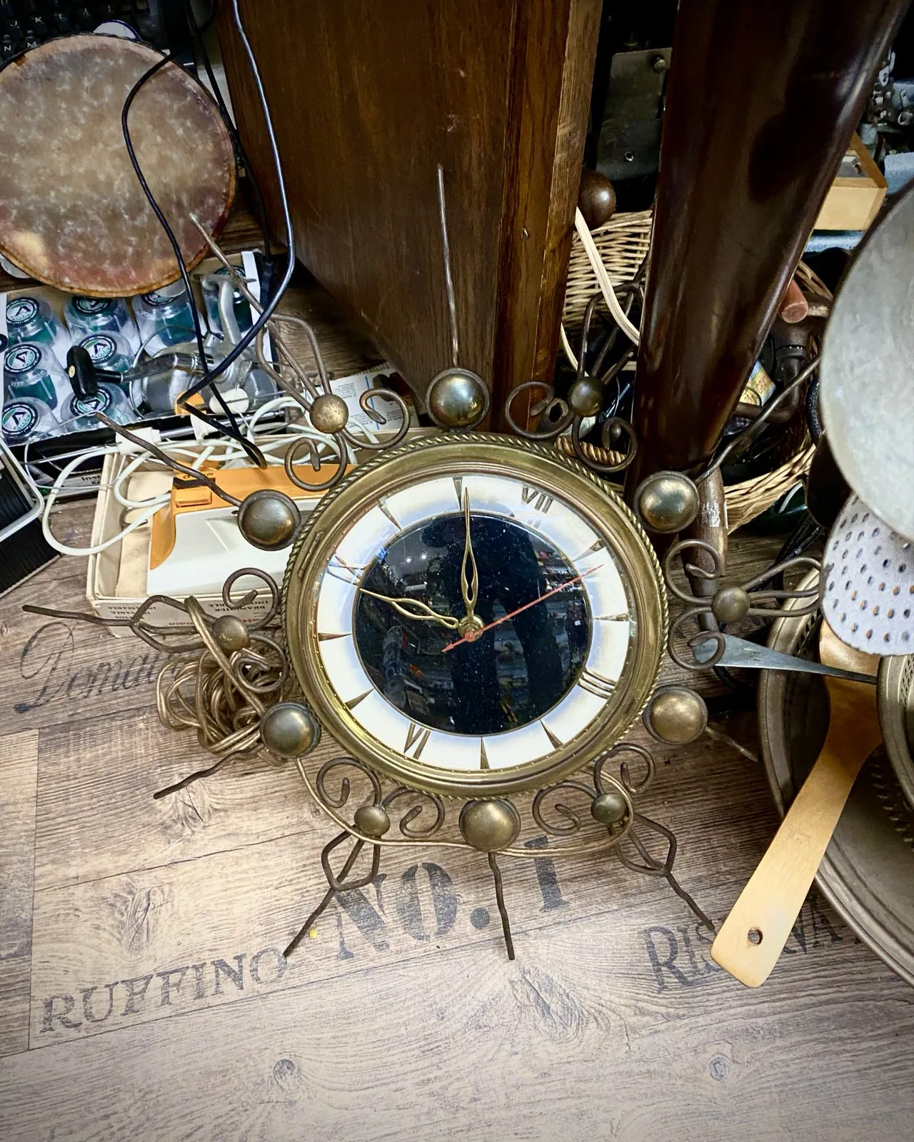 This starry, pointy clock in a thirft shop points at five minutes to nine.