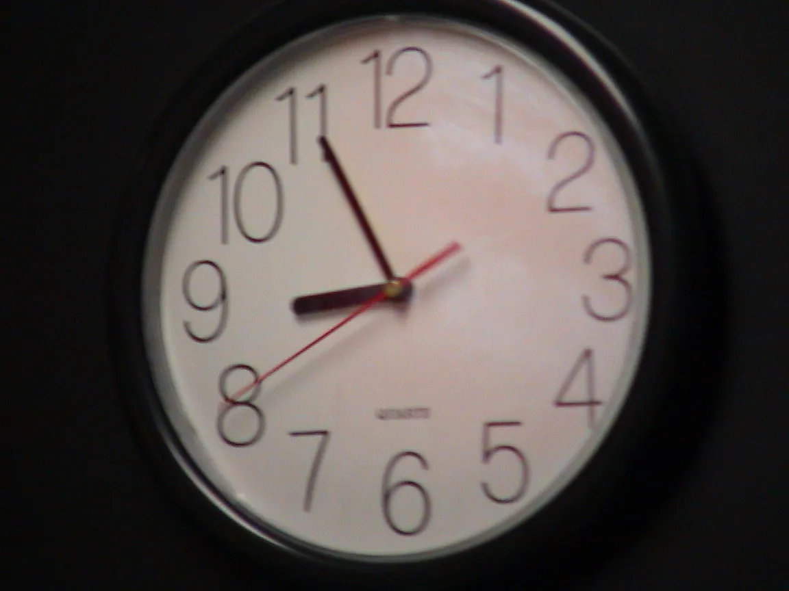 It is five to nine on this wall clock.