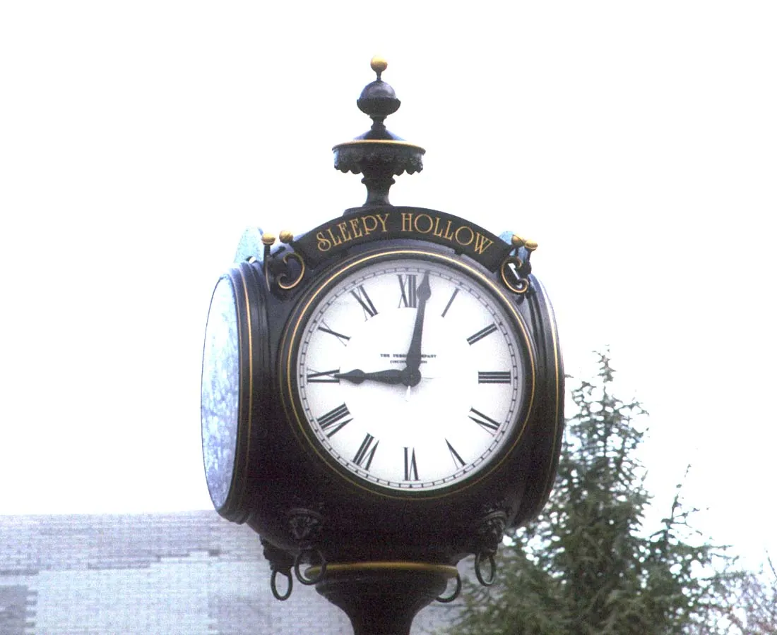 The Sleepy Hollow clock, which is a large cast metal clock on a pole, points at two minutes past nine.