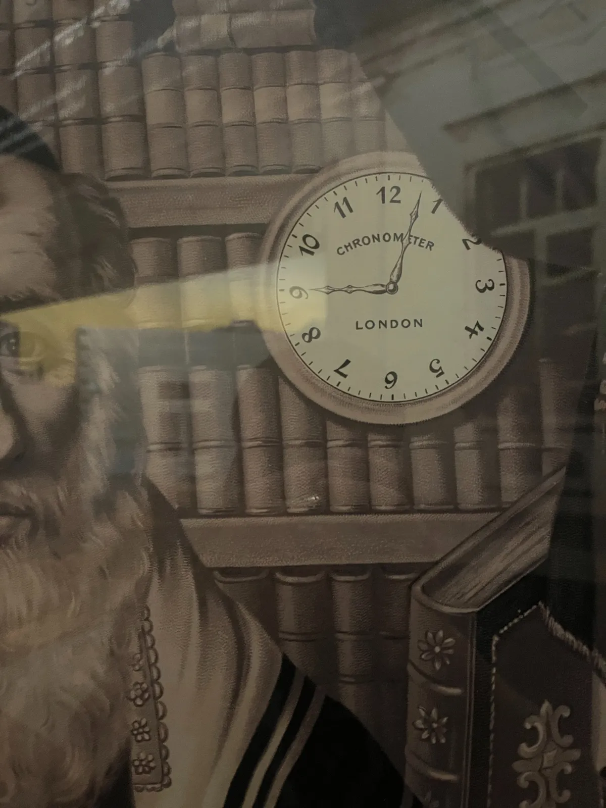 A clock on a poster. It points at 3 minutes past 9.
