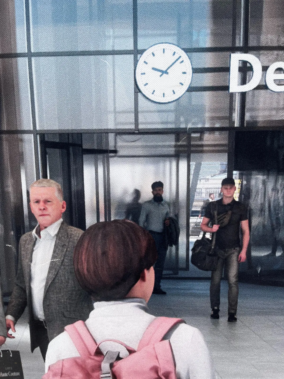 This seems like a normal image of a train station, but when you look a bit closer it becomes more and more uncanny. The people look a bit nightmarish, and the clock is off: the hour hand seems to point at approximately a quarter to 10, while the minute hand points at 8 minutes past. The image is clearly generated by an AI, and everybody involved in printing this thing should be ashamed. Since I’m human I get to decide that this clock points at 8 minutes past 9.