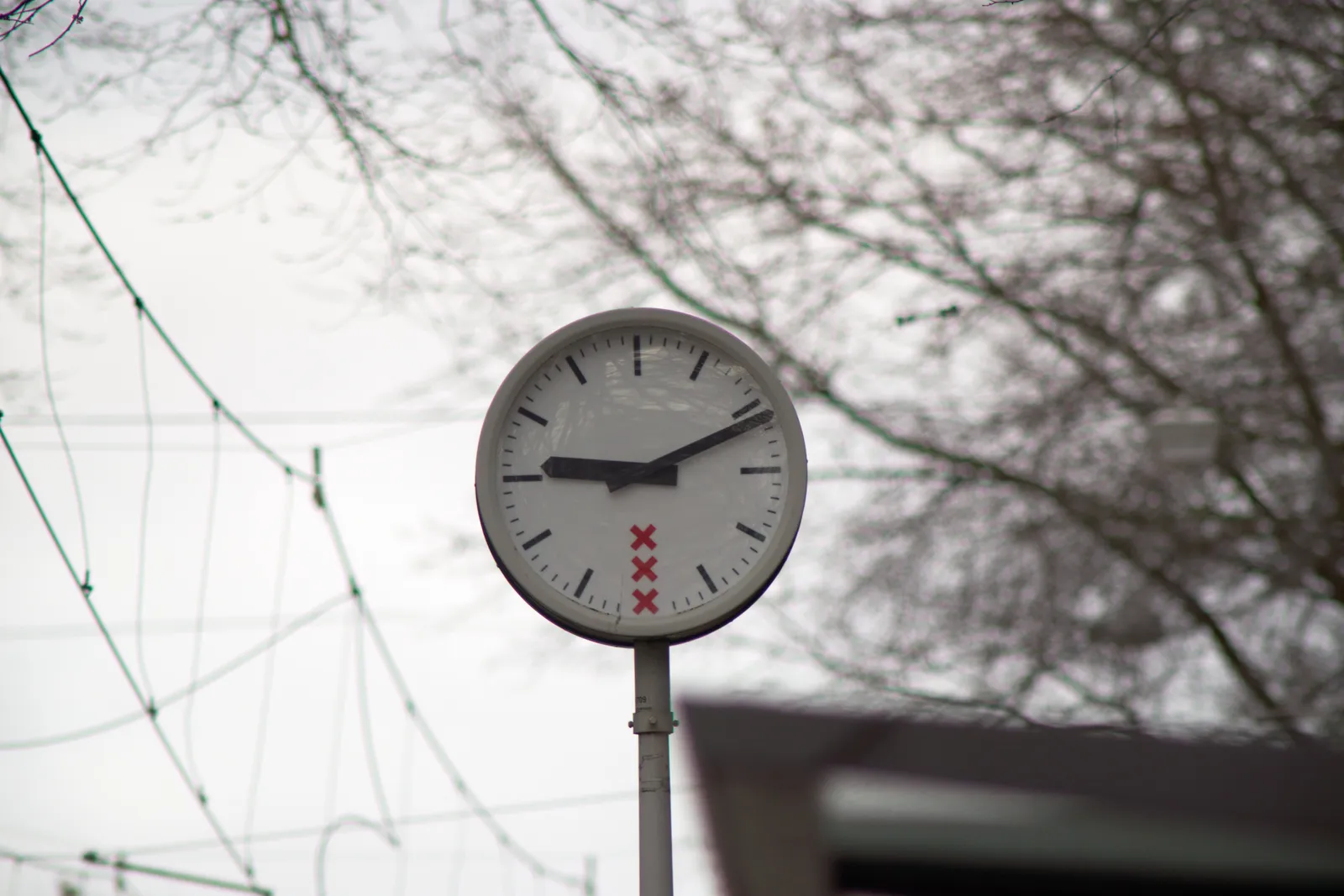 A clock in Amsterdam points at 11 minutes past nine.