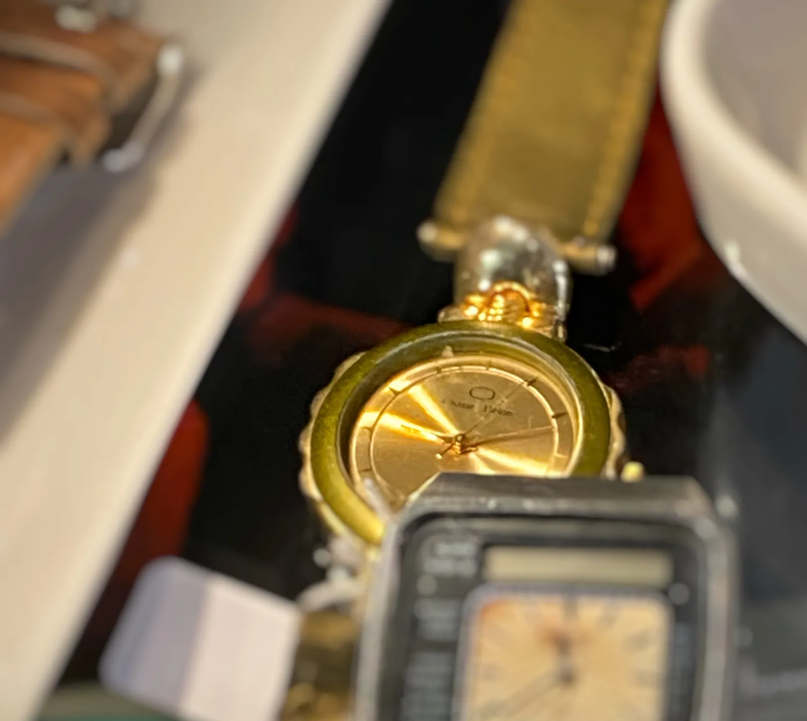In front there a blurry watch. Behind it is a watch that’s in focus. It points at approximately 11 past 9.