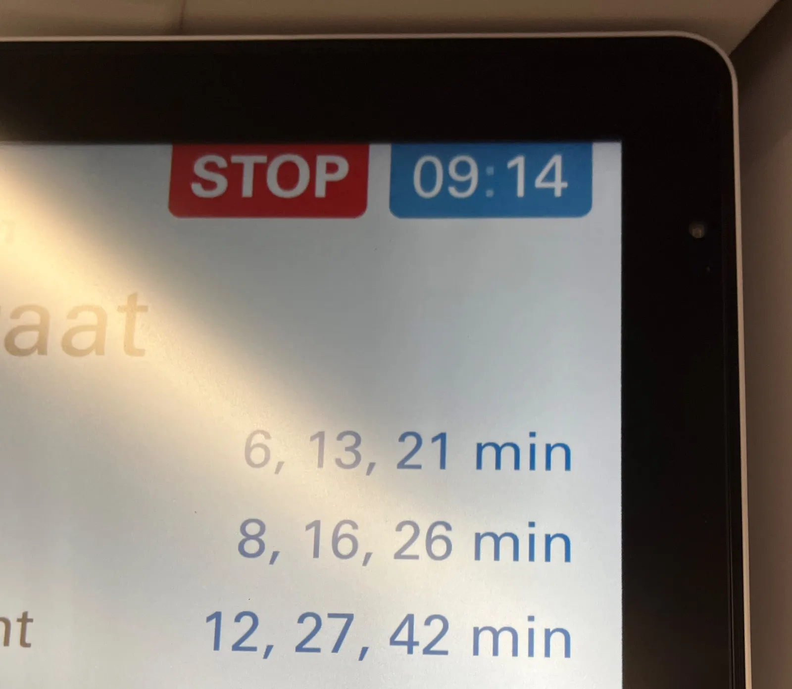 A clock on a display in a tram says that it is 14 past nine. 