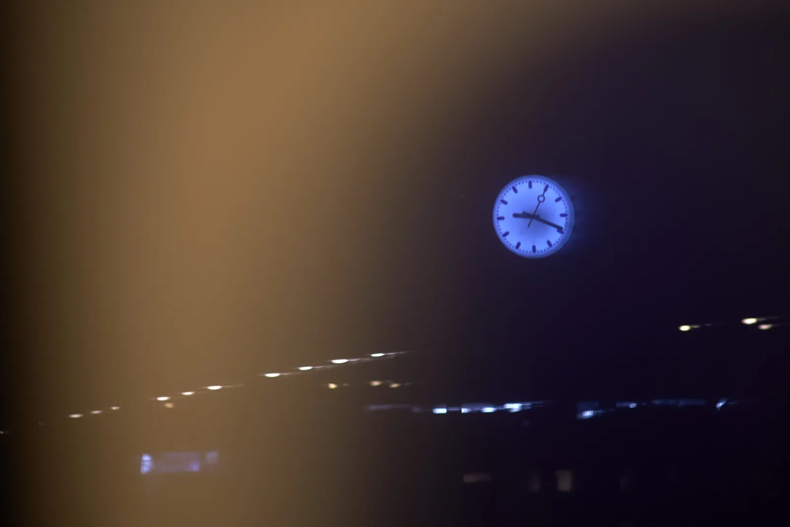 The whole picture is very dark and a bit blurry, but a clock can be clearly seen. It points at 19 minutes past 9.