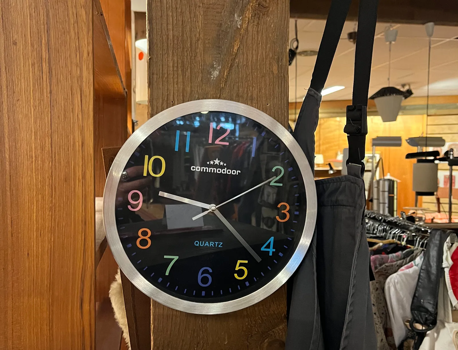A colourful clock in a thrift shop points at 22 past nine.