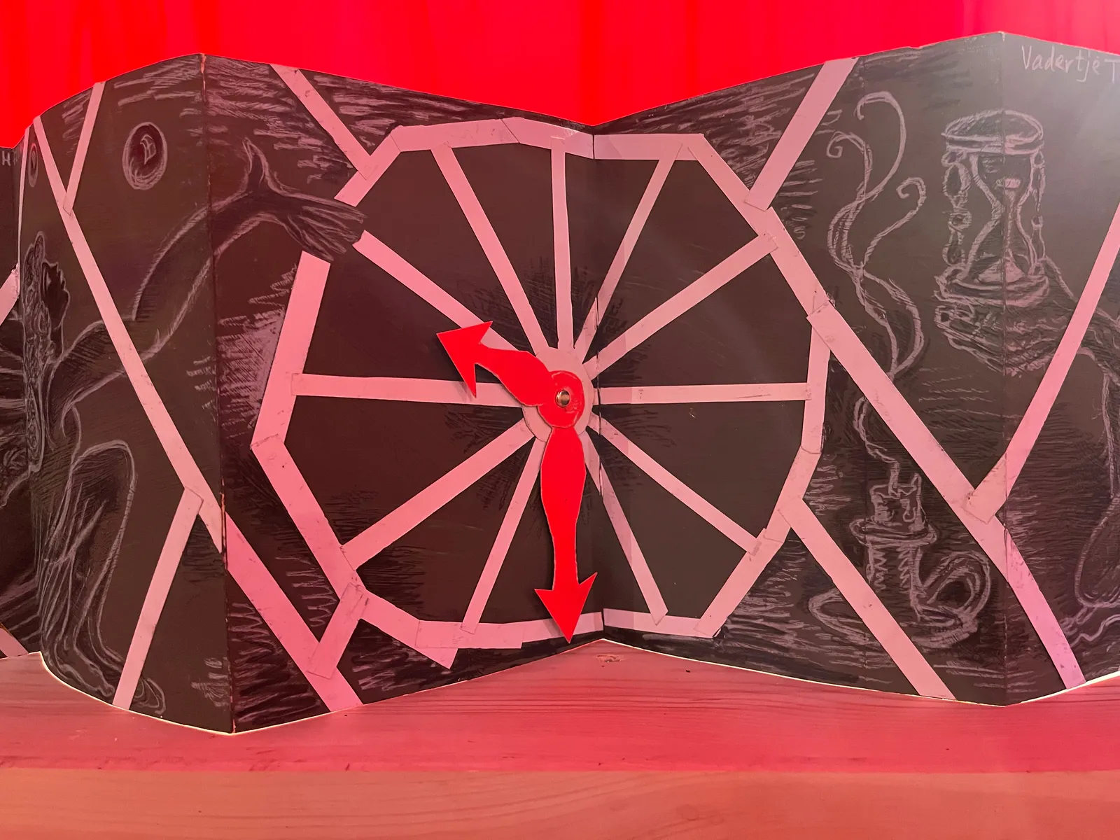 A detail of a large work of art with a clock on it. It points at nine thirty.