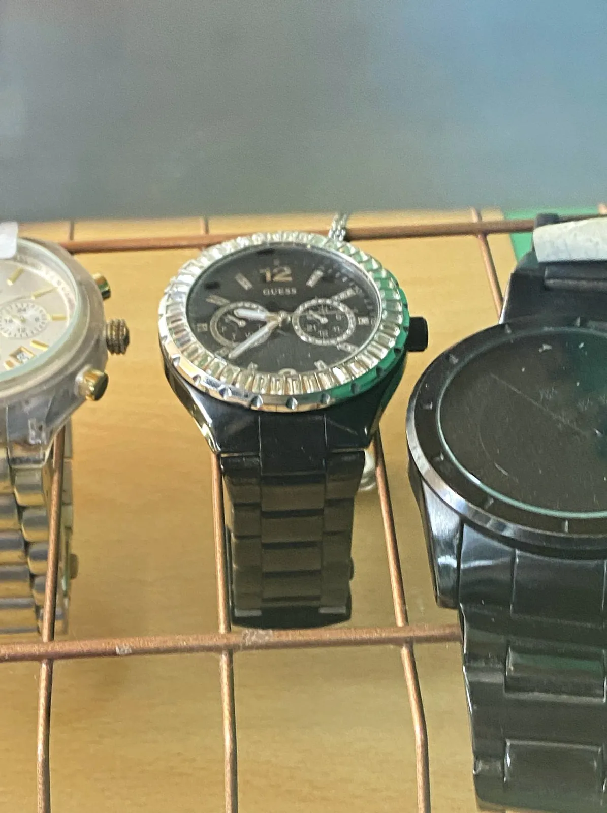 A few watches for sale. On one of them you can see the time. It is 22 minutes to 10.