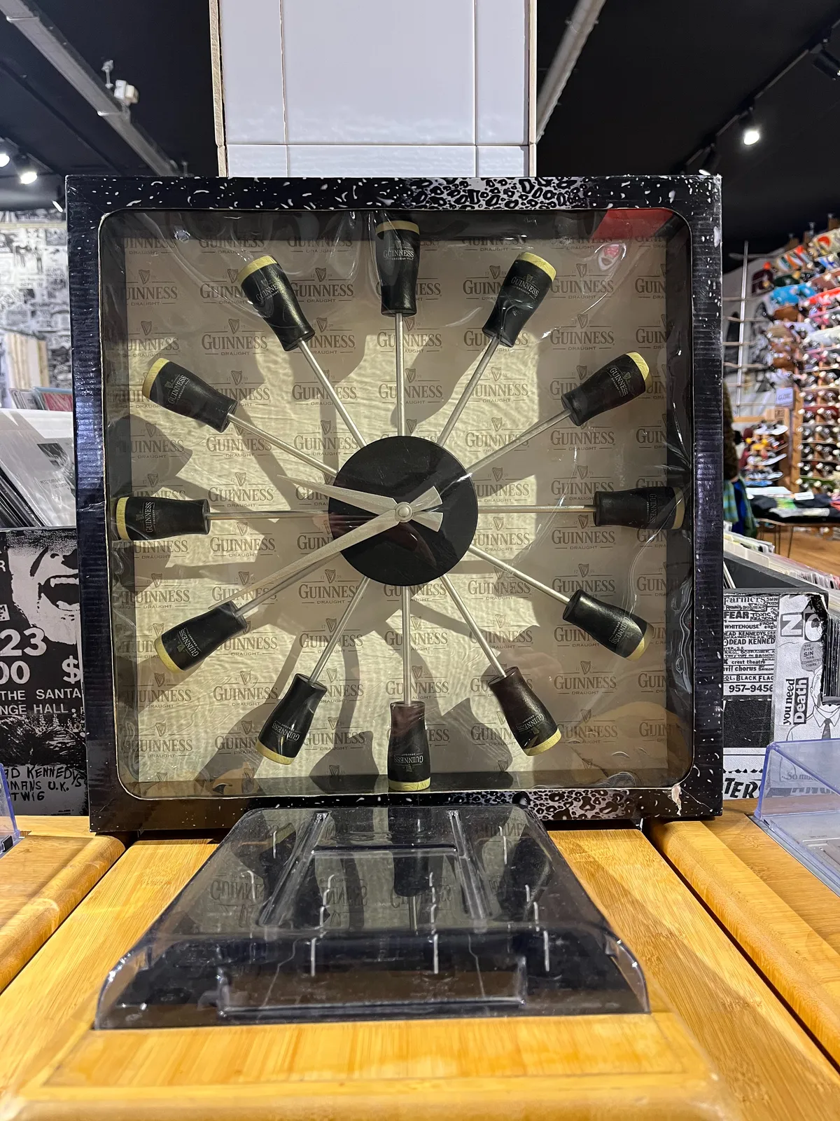A clock made from spokes with glasses of dark Guinness beer at each end. It points at approximately 20 to 10.
