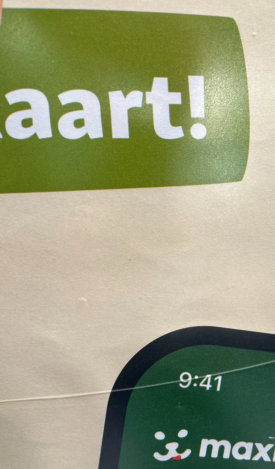 A detail of a printed advertisement. Aart is written in large letters. There’s also the left top corner of a smartphone with the timestamp 9:41