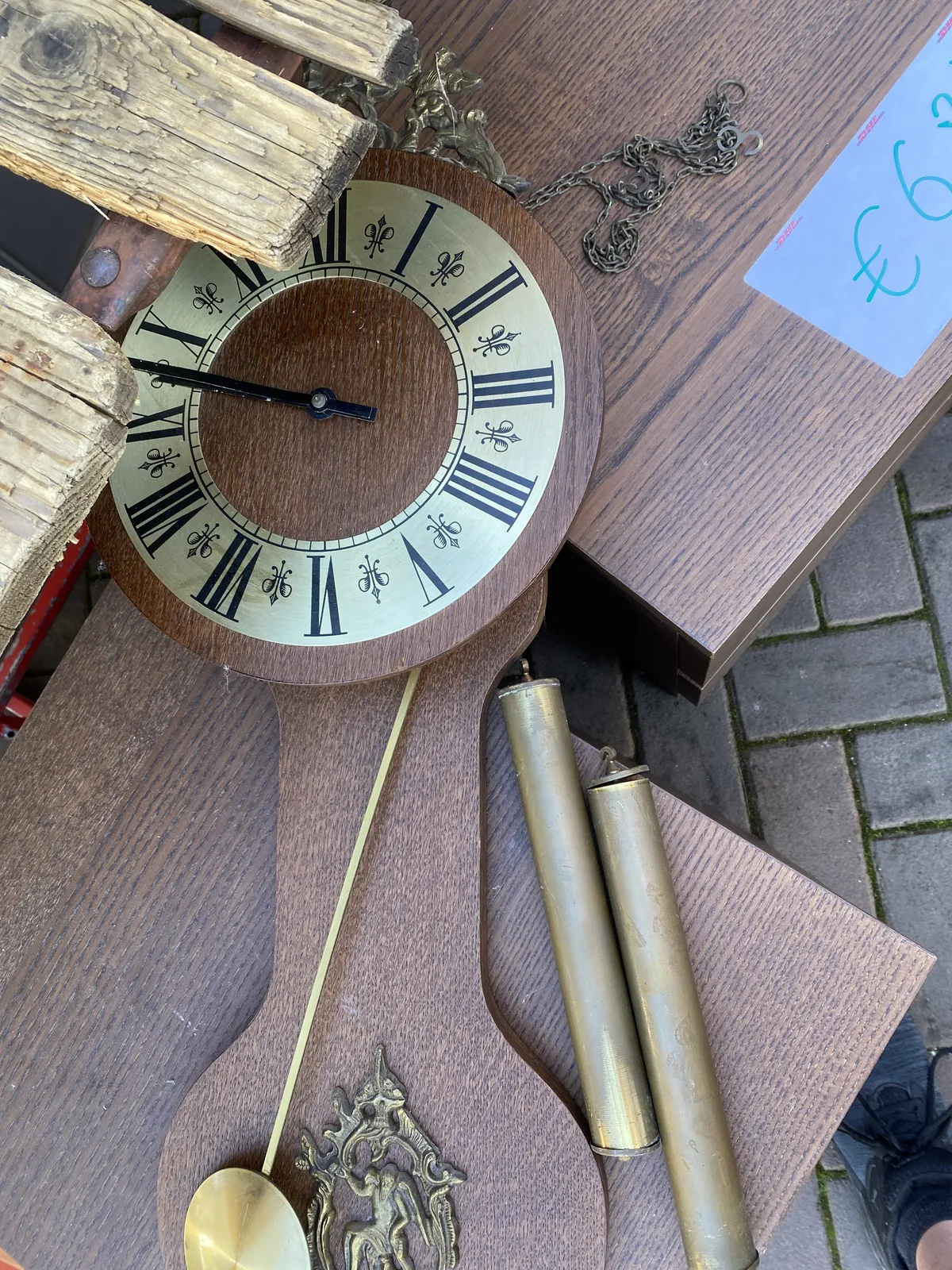 A wooden clock. It looks like it’s thrown down without too much care. It points at 12 minutes to 10.