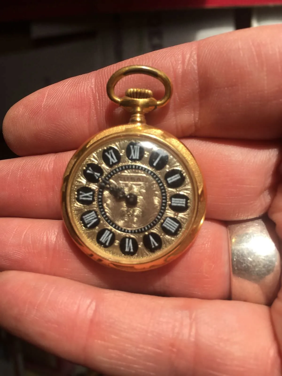 It is ten to ten on this little golden watch.
