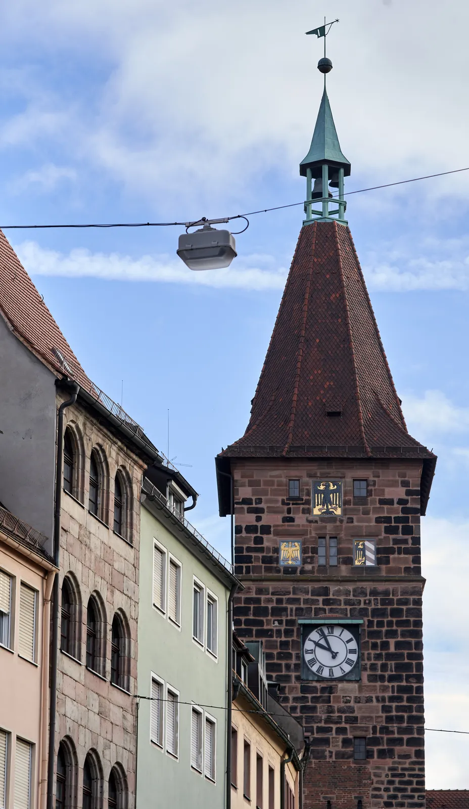 A clock on a rather massive, old tower. It points at 4 minutes to 10.