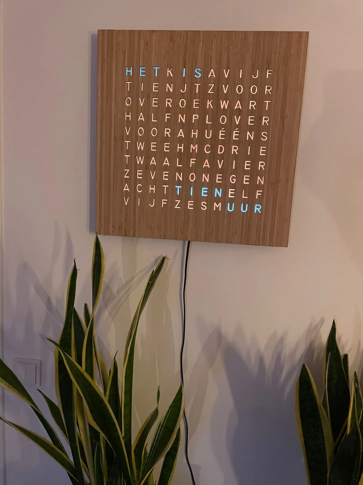 A clever clock made from Dutch words. It can tell the time with five minute accuracy by lighting up different words in blue. Right now it says that it is ten o’clock.