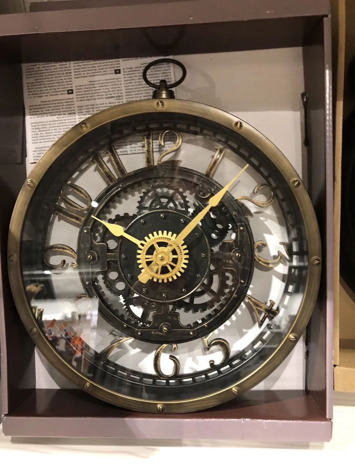 A clock in a box points at 7 past ten.