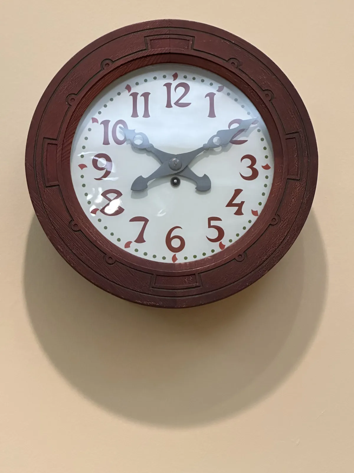 A well designed clock, with some very interesting numbers on it, and some beautiful ornaments. It points at 10 minutes past 10.