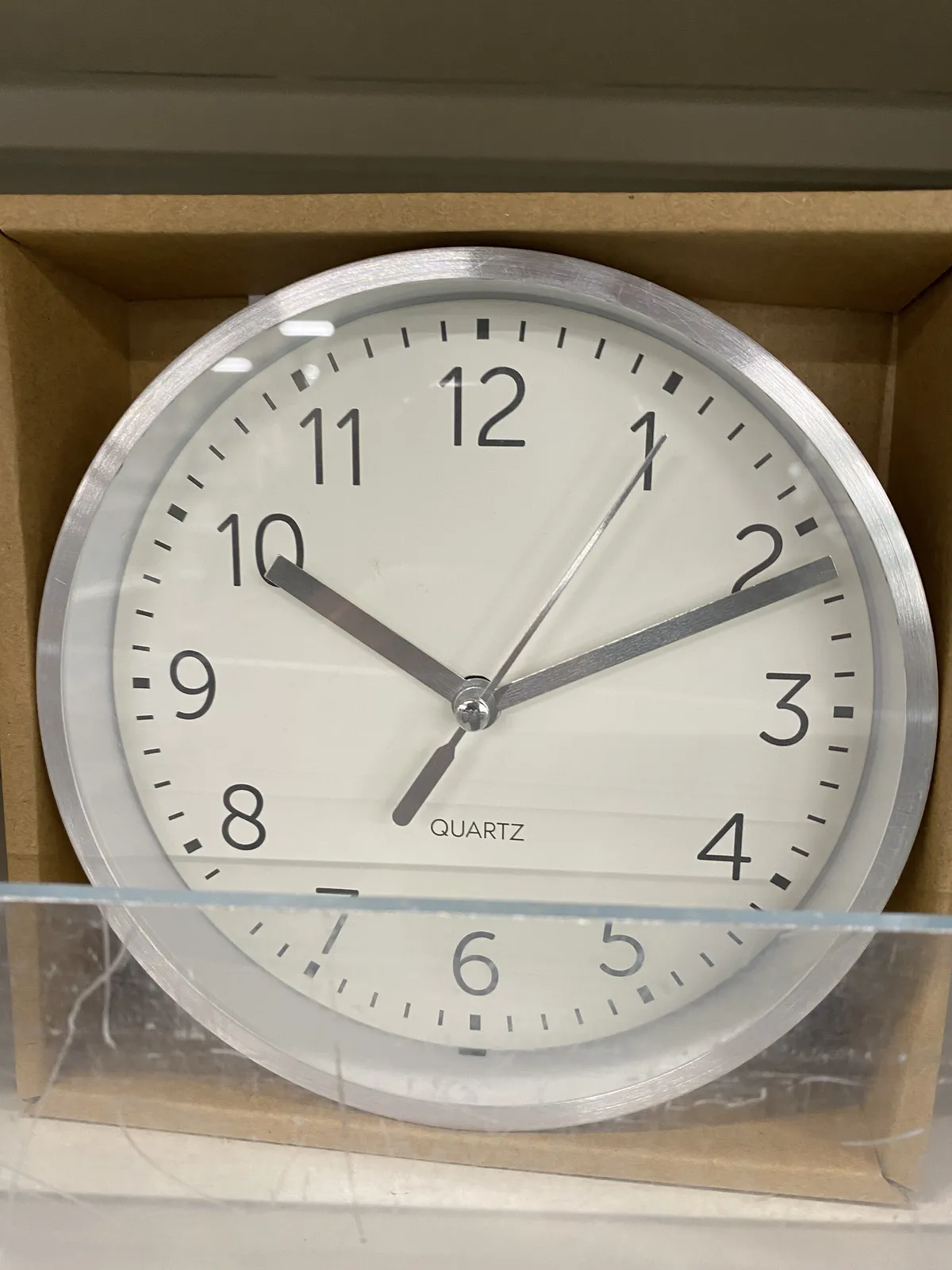 A boxed clock points at 11 past 10.